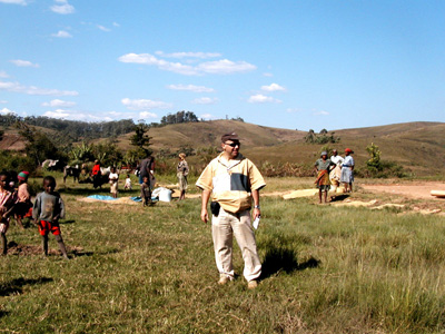 Danilo Barbero walking in a rural landscape with a group behind him