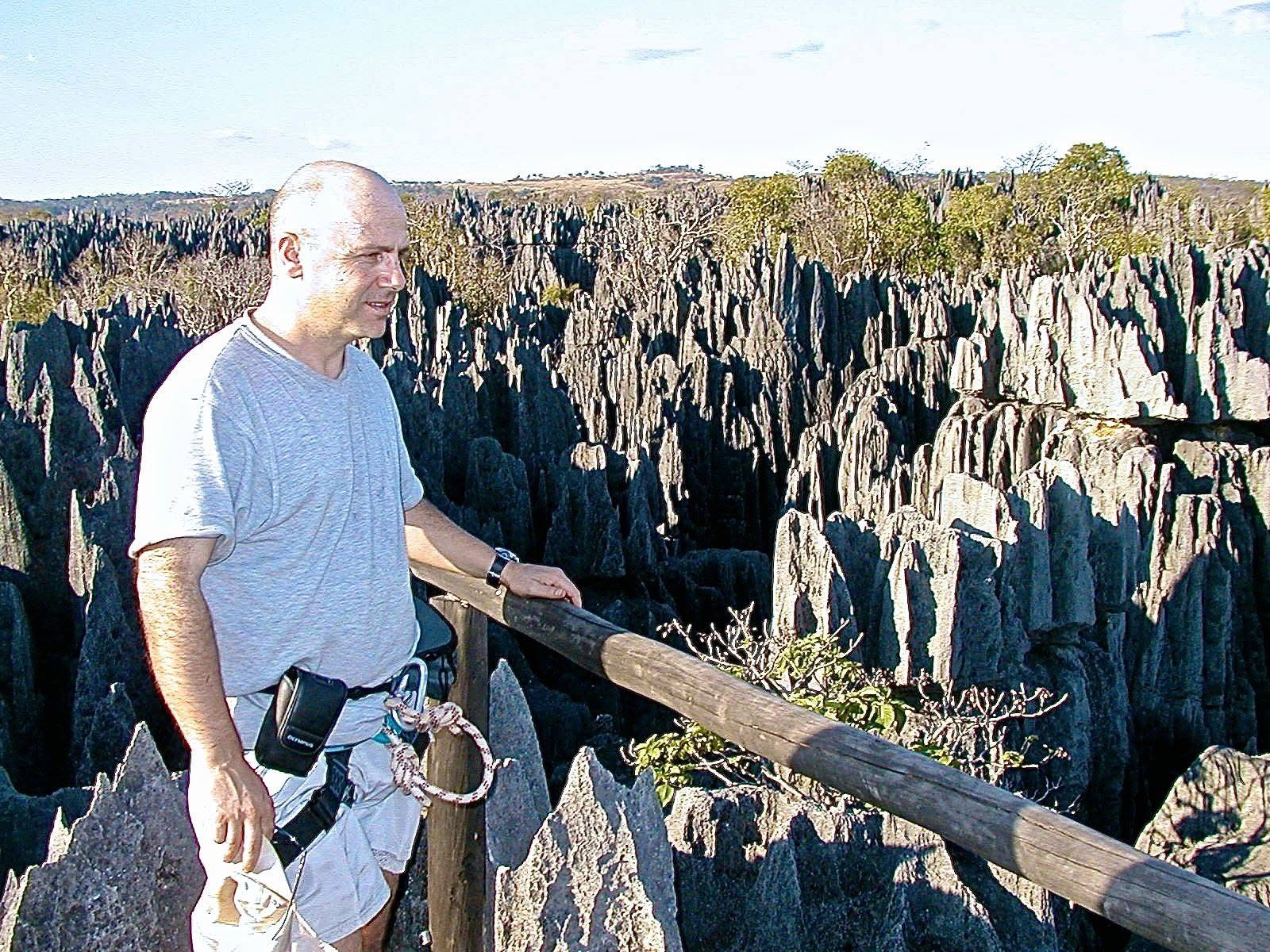 Danilo Barbero at a railing overlooking pointed limestone formations