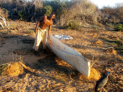 A person working with a long piece of timber outdoors