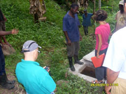 Danilo Barbero and colleagues examining a concrete community infrastructure installation