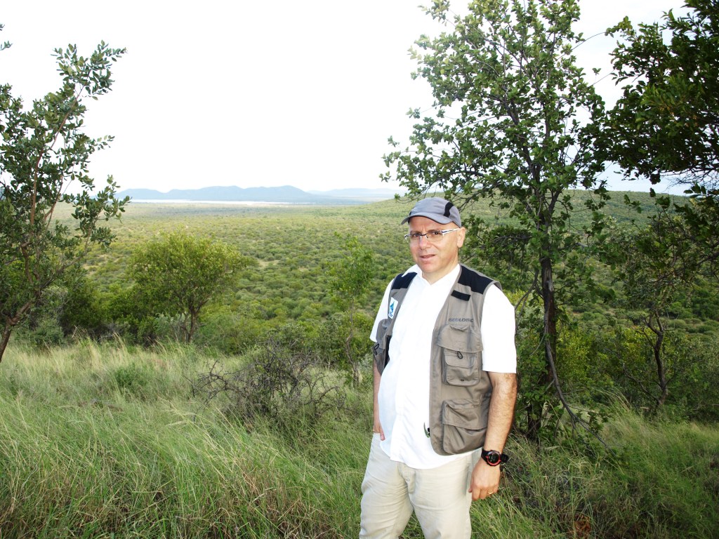 Danilo Barbero on a hillside overlooking a green landscape