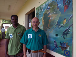 Danilo Barbero and a colleague beside an illustrated natural park map