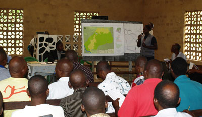Participants attending a workshop with a protected-area map displayed at the front